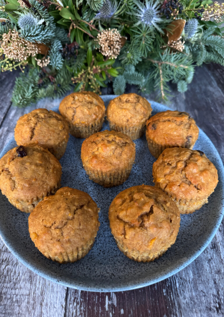 Carrot Macadamia and Cranberry Muffins served on a blue plate