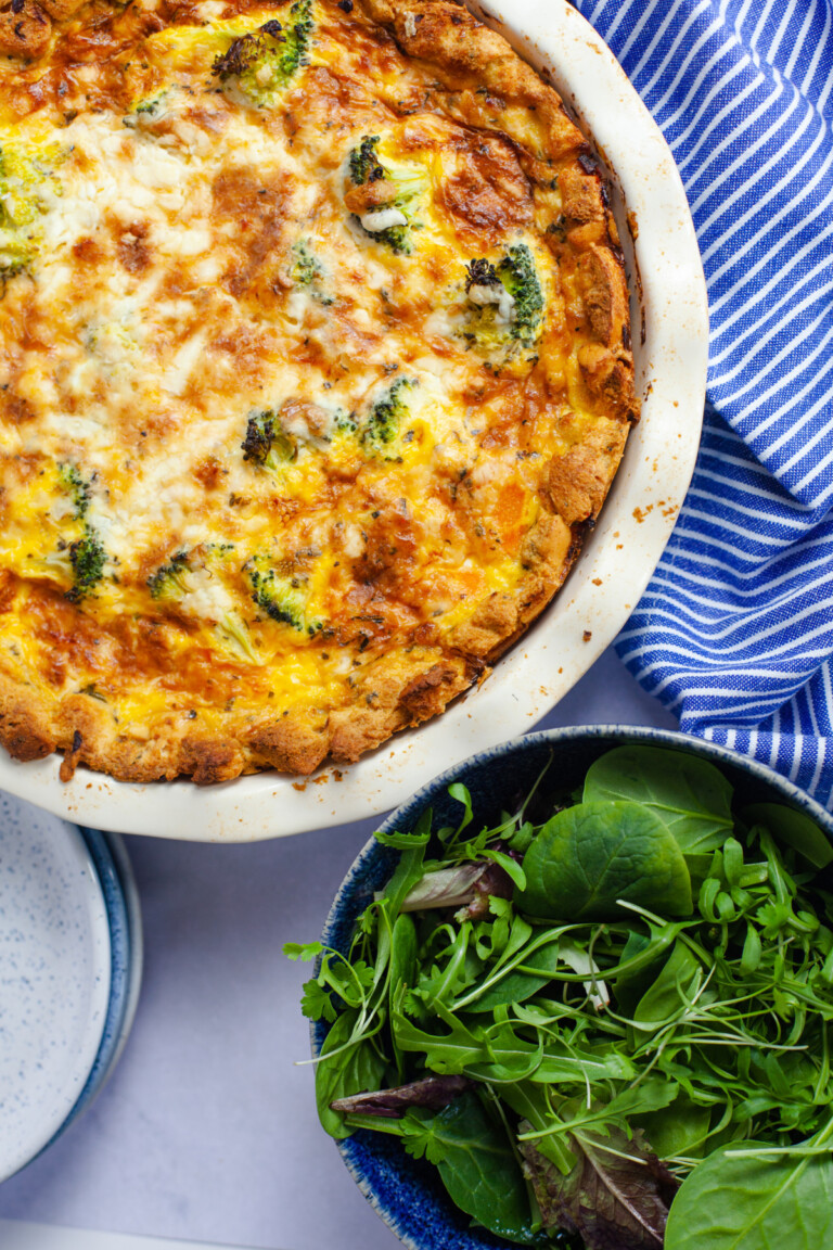 Crunchy Crouton Egg Pie in a pie dish served with salad