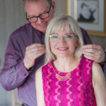 April and Guy Harris. Guy is doing up a gold necklace for April