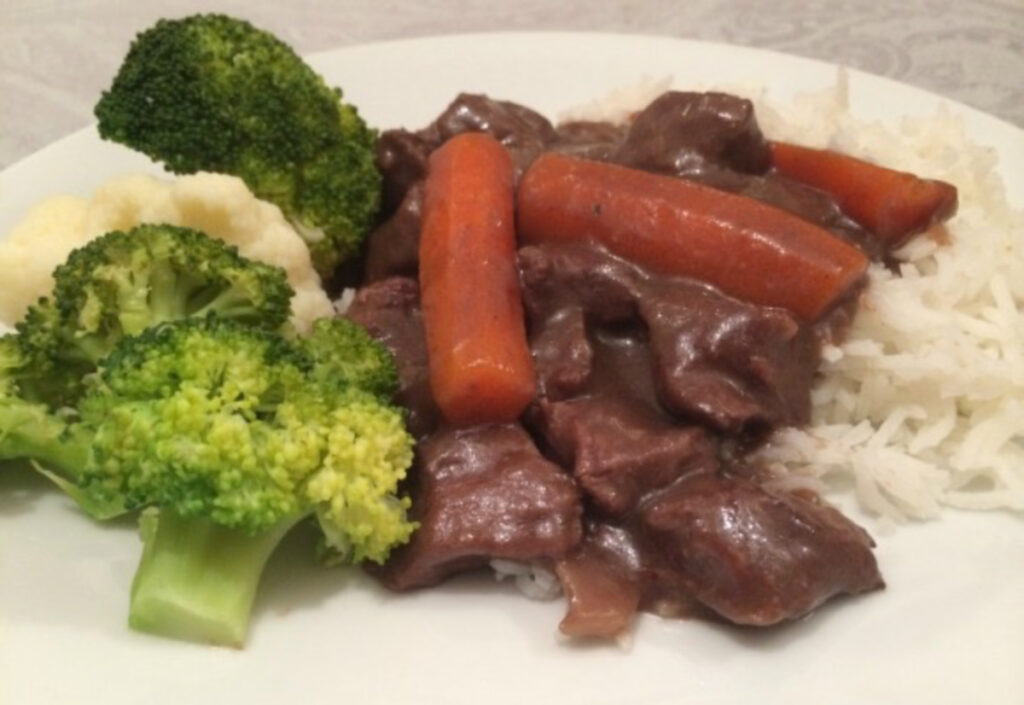 Easy Boeuf Bourguignon served over rice with broccoli on the side.