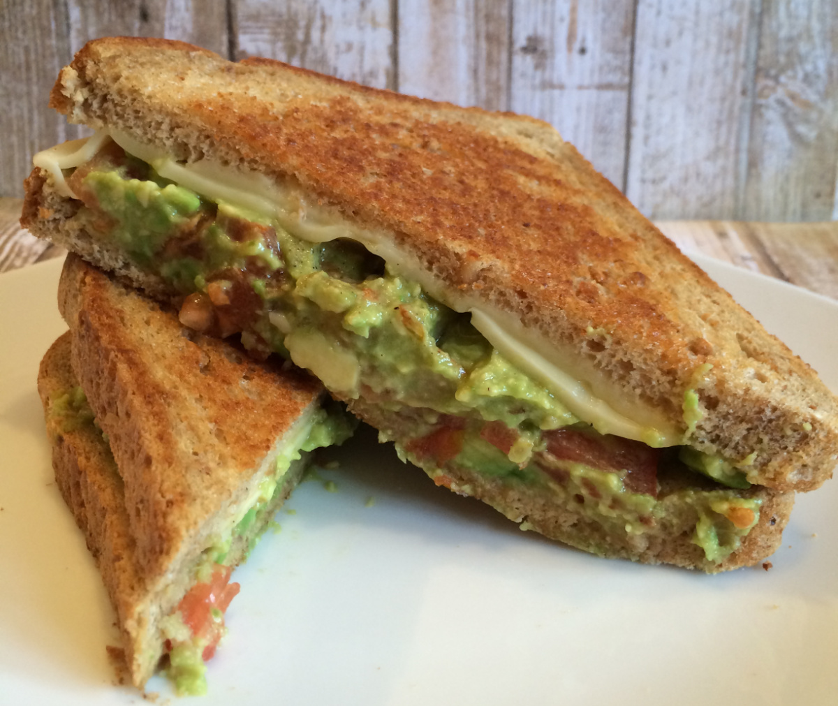 Guacamole cheese toastie served on a white plate