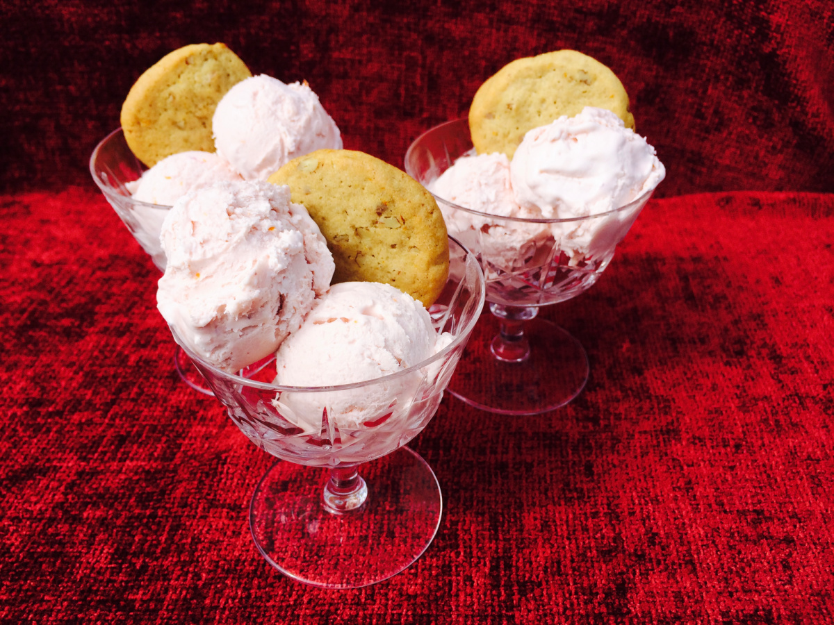 3 crystal dishes filled with three scoops of Blood Orange Ice Cream