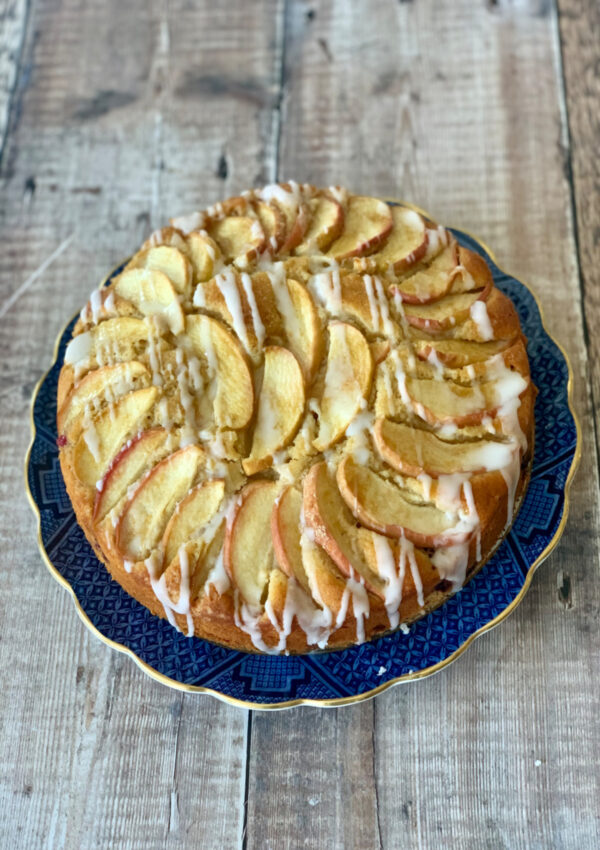 A whole Apple Cinnamon Yogurt Cake served on a Blue Willow plate