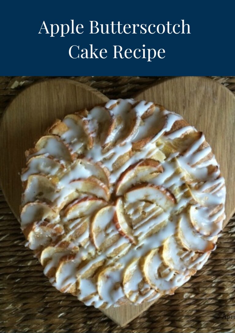A whole Apple Butterscotch Cake served on a heart shaped wooden board