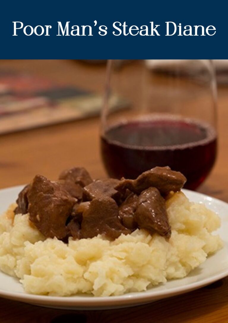 Poor Man's Steak Diane served over mashed potatoes with a glass of red wine in the background