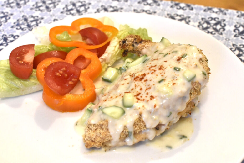 Oven Baked Crispy Mediterranean Chicken served alongside some salad