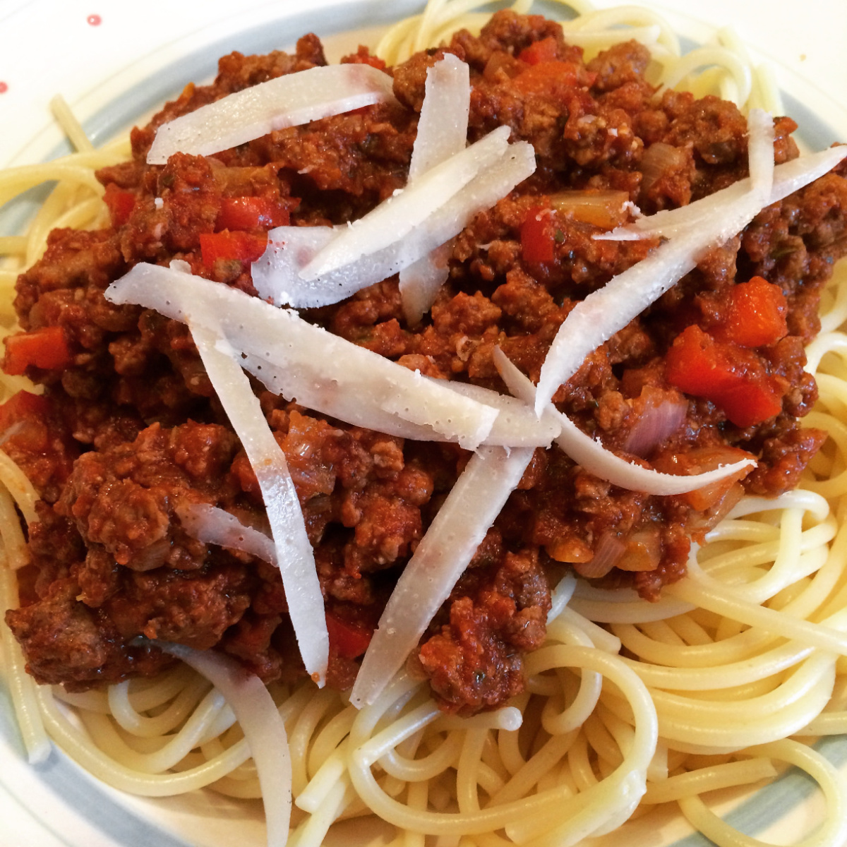 Vegetarian Spaghetti Bolognese served with vegetarian cheese on top