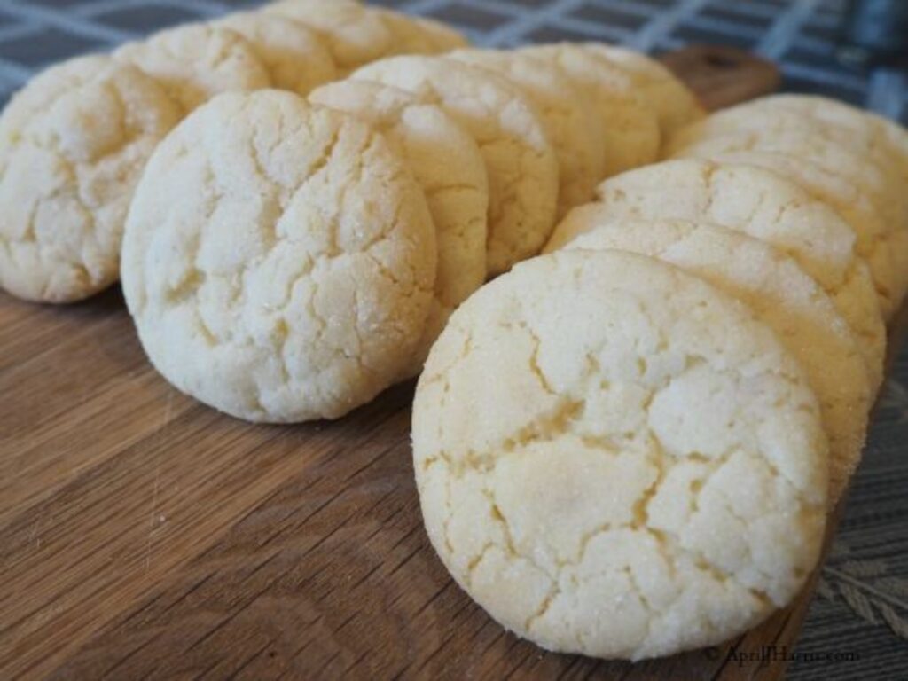 3 rows of Lemon Crinkle Cookies on a bread board