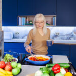 header image for healthy choices post - April J Harris cooking in her kitchen. Bowls of fruit, vegetables, citrus fruit are arranged on the kitchen island