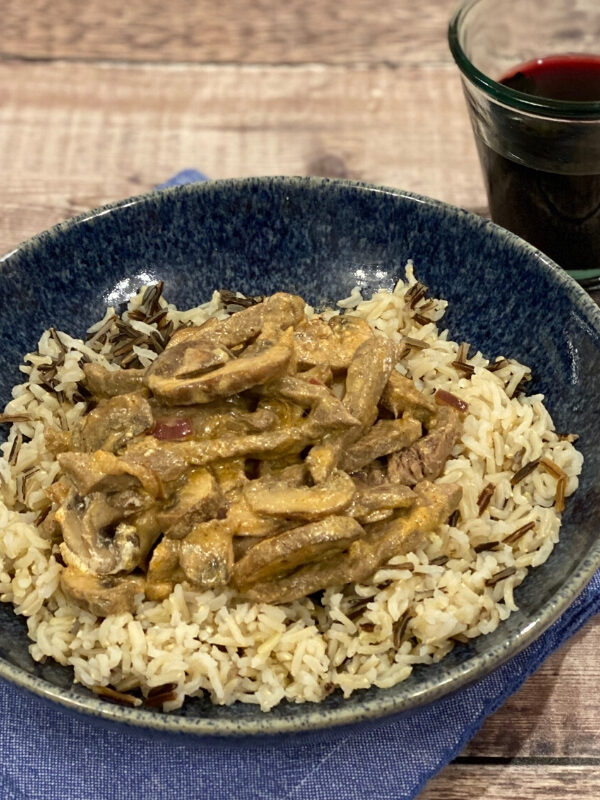 Quick and Easy Beef Stroganoff recipe served on a blue plate