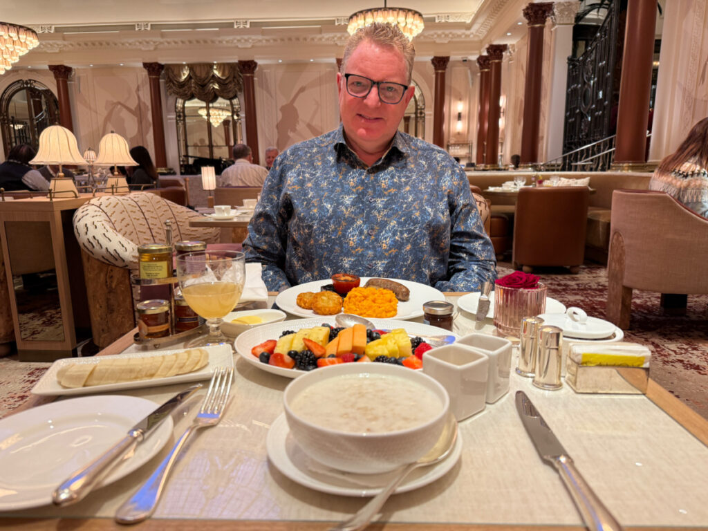 Guy Harris sitting at a table in The Gallery Restaurant at the Savoy Hotel at breakfast