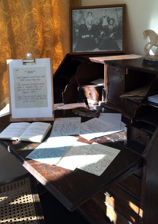 Lady Nuffield's desk with various pictures, diaries and letters on display