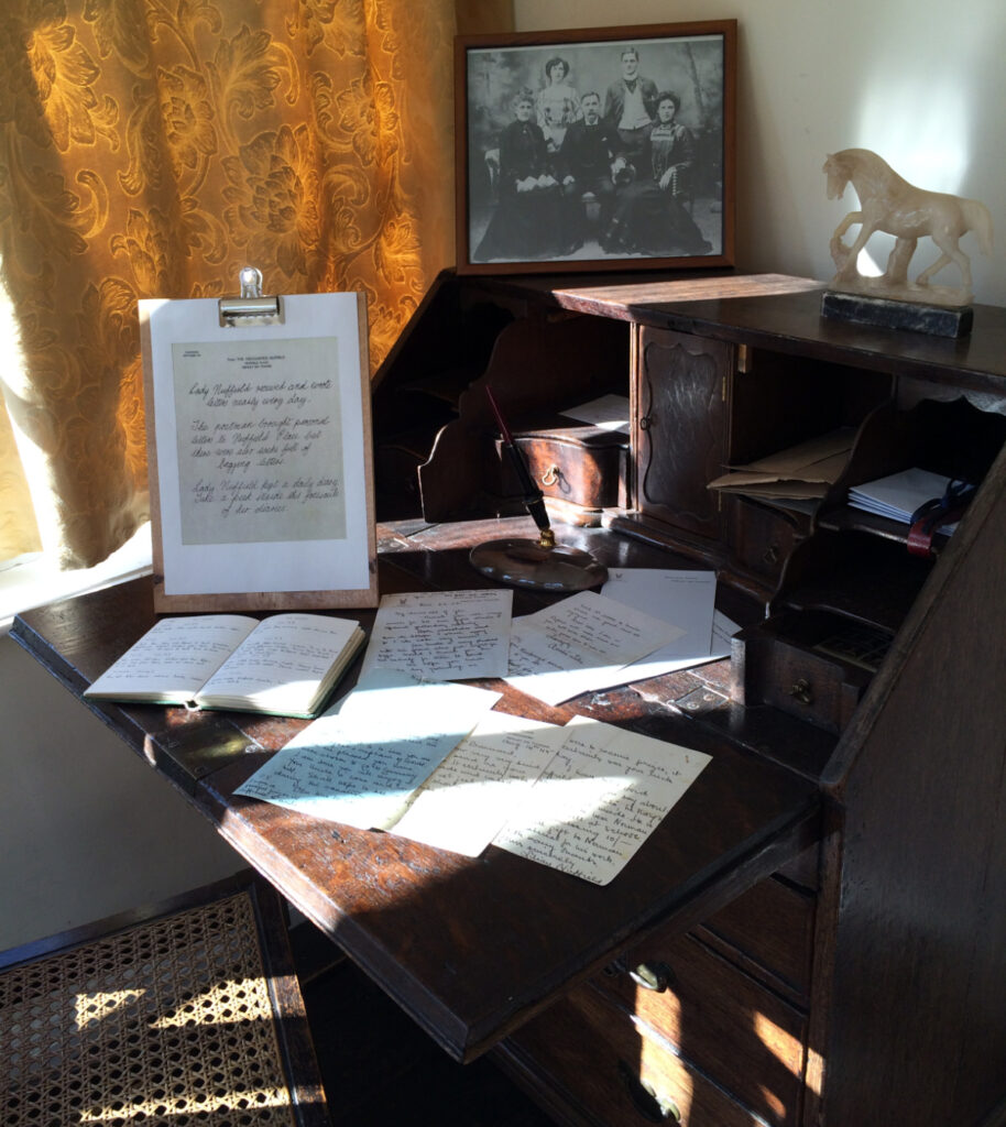 Lady Nuffield's desk with various pictures, diaries and letters on display