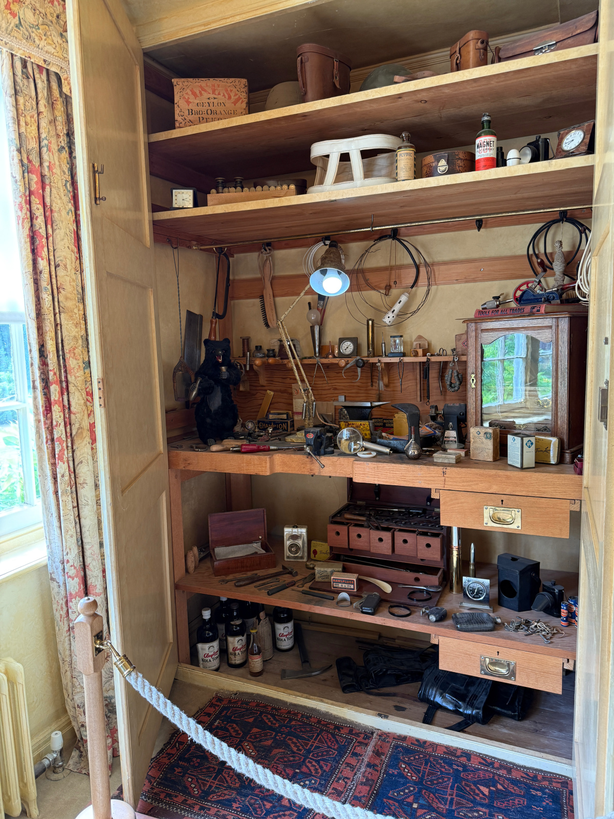 Lord Nuffield's bedroom cupboard at Nuffield Place.. The cupboard is full of tools.