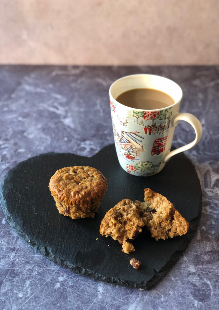 Oatmeal Raisin Muffins served on a heart shaped slate with a coffee on the side.