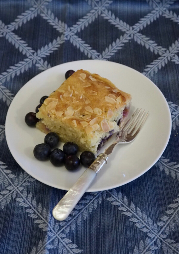 Blueberry Bakewell Tart Squares - a square served on a white plate with blueberries alongside