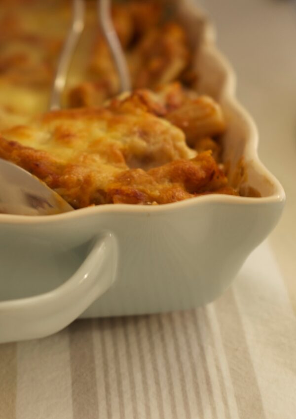 A corner view of Spinach Florentine Casserole being spooned out of the dish as it is being served