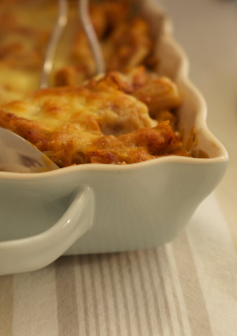 A corner view of Spinach Florentine Casserole being spooned out of the dish as it is being served
