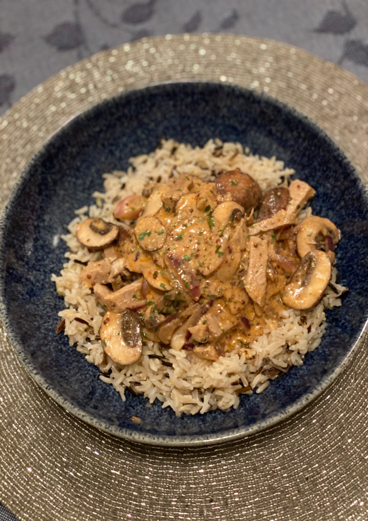 Beef Stroganoff served over rice in a blue bowl