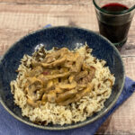 Beef Stroganoff served over rice in a blue bowl