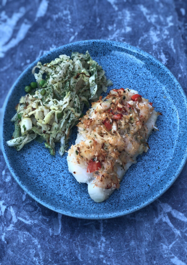 Spicy Crab Topped Cod served with a side of cabbage