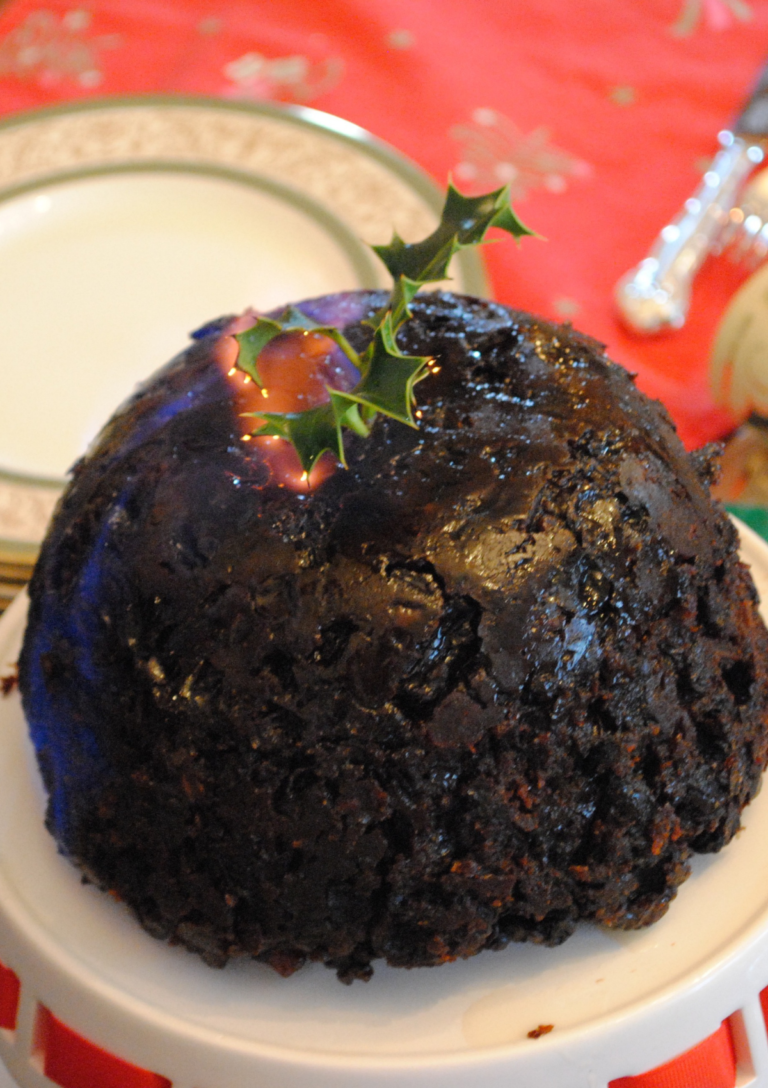 Old Fashioned Christmas Pudding alight on a serving plate