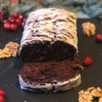 Chocolate and Cranberry Quick Bread with Cinnamon Glaze served on a black slate tray