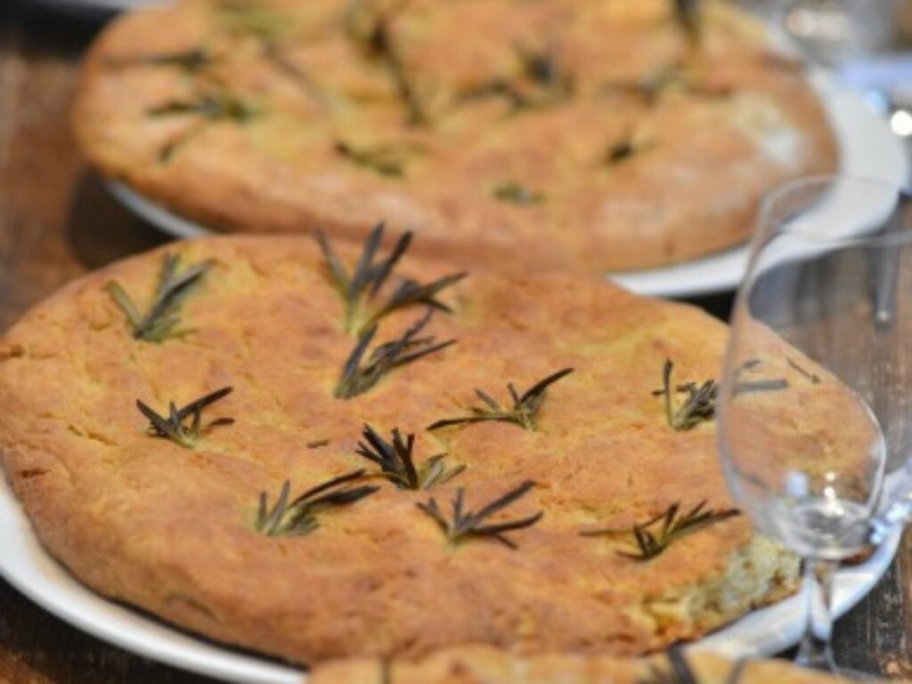 Three soda focaccia breads on paper plates