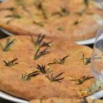 Three soda focaccia breads on paper plates