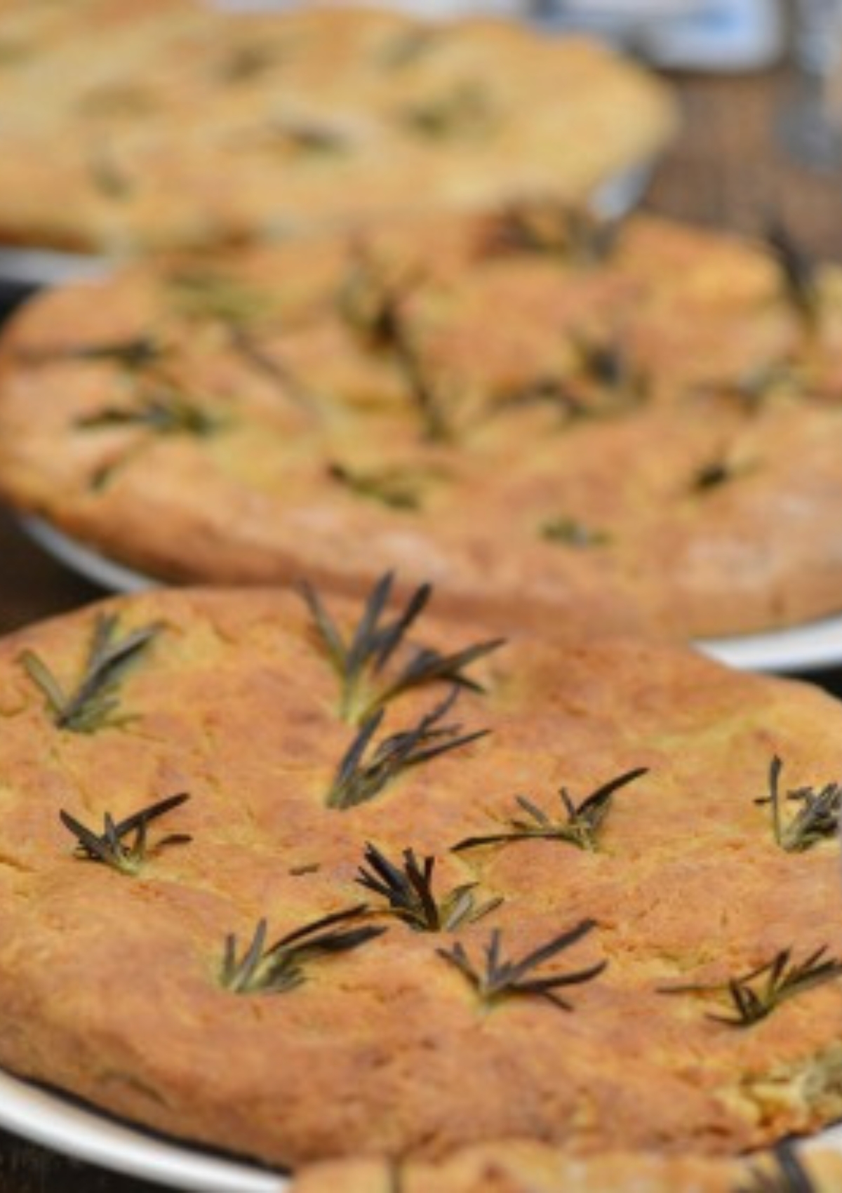 Three soda focaccia breads on paper plates
