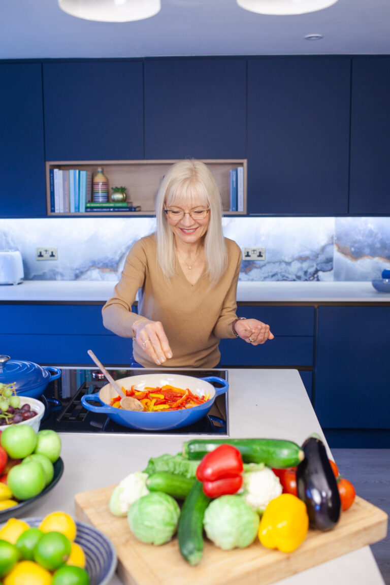 April J Harris cooking Red Pepper Crostini Topping on the stovetop in her kitchen