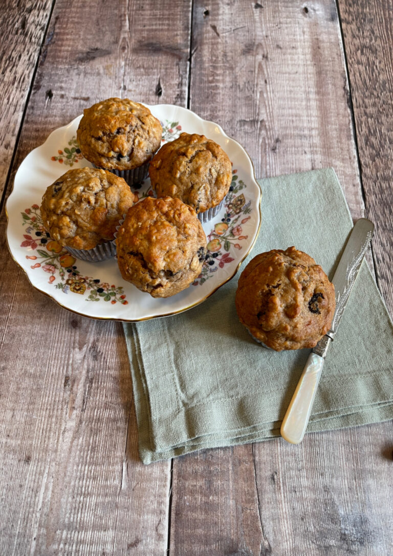 Banana Oatmeal Raisin Muffins served on a plate with one alongside
