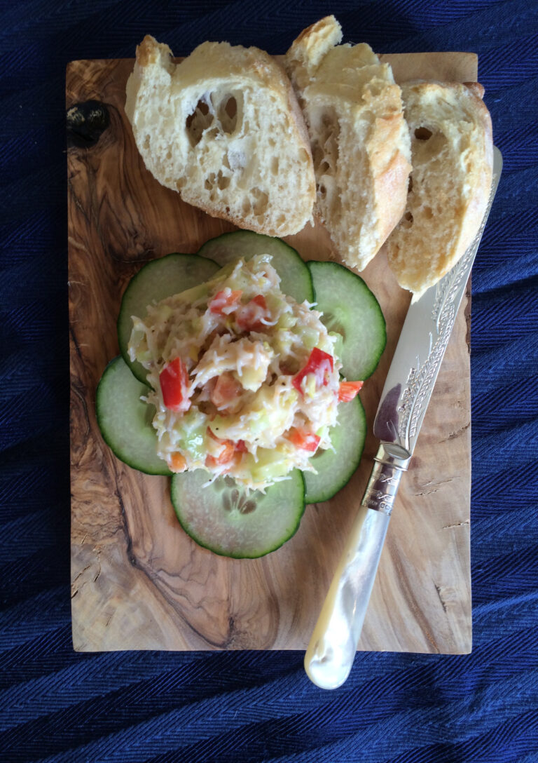 Easy Crab Pate on a bed of cucumber served on a board