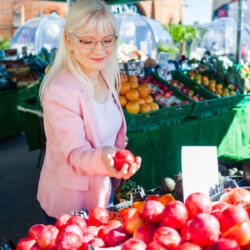 September Edition - a woman shopping in a fruit and veg market