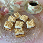 Raspberry Snow Bars cut and served on a crystal plate