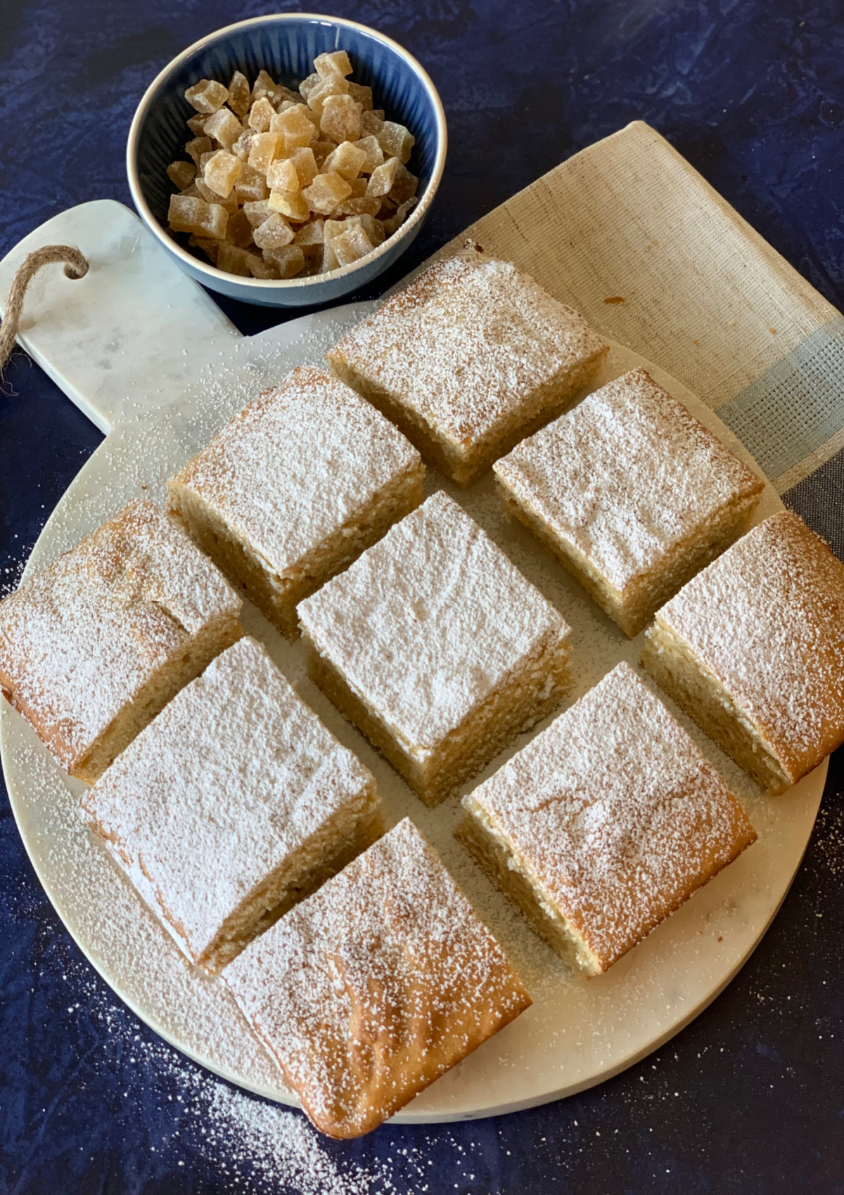 My Mom’s recipe for Maple Gingerbread cut in squares and served on a round marble plate