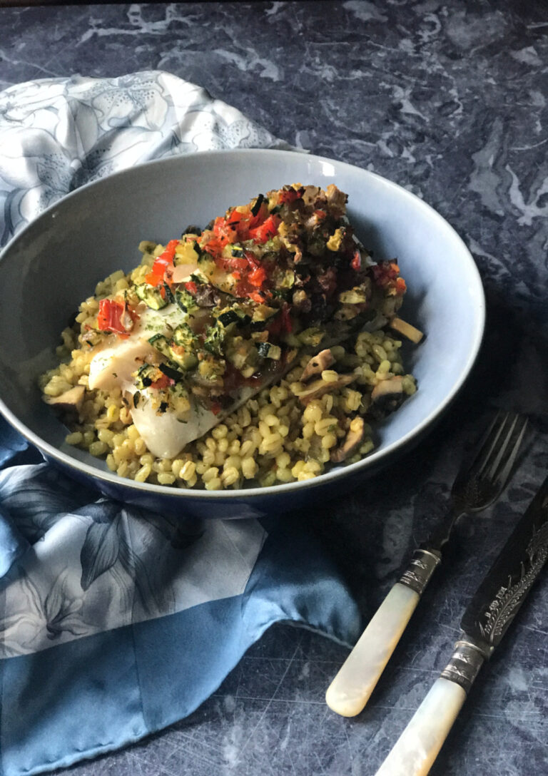 Baked Cod with a Sautéed Vegetable Topping served in a blue bowl