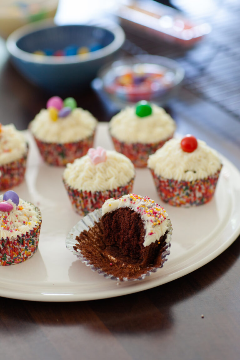 Chocolate Cupcake Recipe, frosted chocolate cupcakes one with a bite taken out
