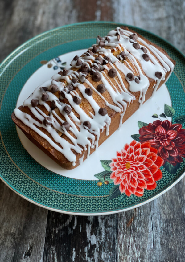 Coffee and Chocolate Chip Loaf served on a cake plate with a floral design