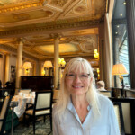 April Harris sitting in one of her favourite Paris restaurants The Café de la Paix