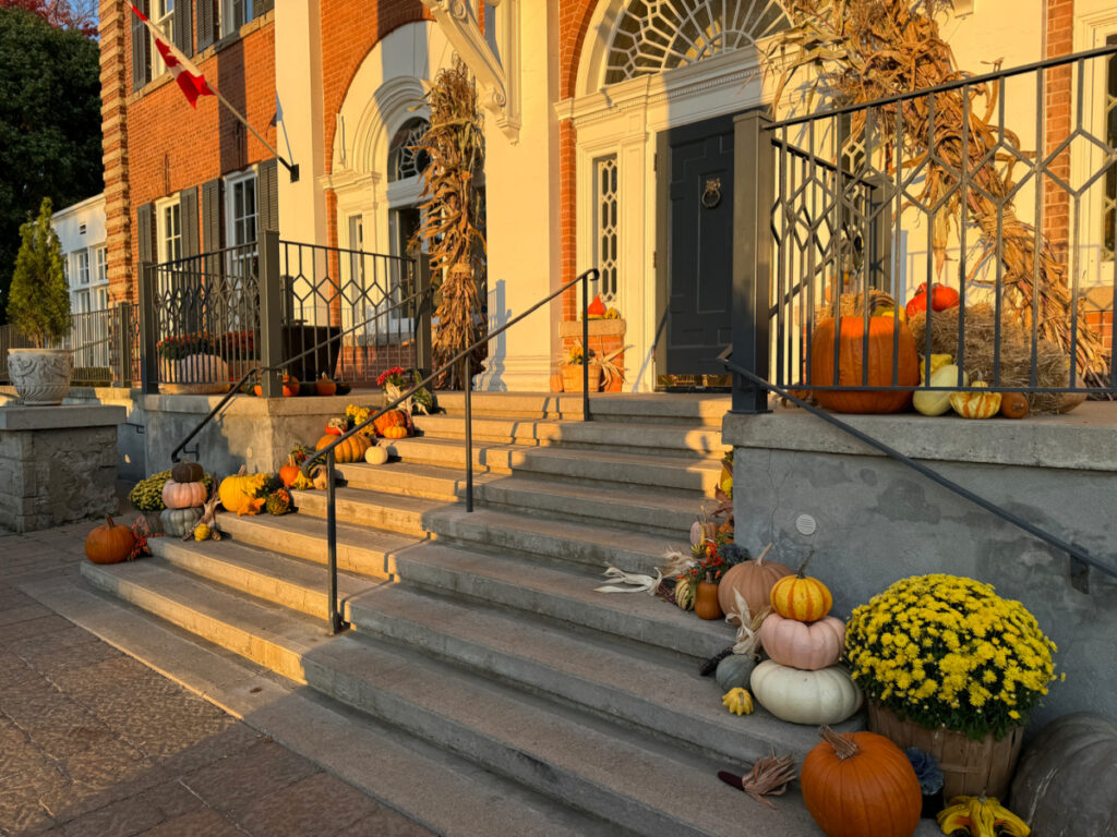 The porch of Langdon Hall, Cambridge Ontario decorated for fall with pumpkins, gourds and squashes