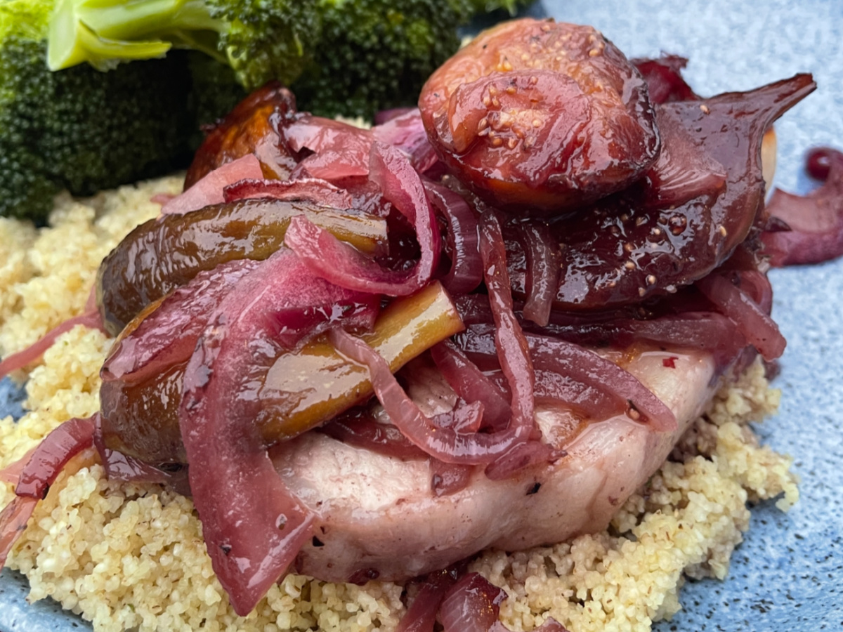 Pork with Figs and Port Sauce served over couscous on a blue stoneware plate