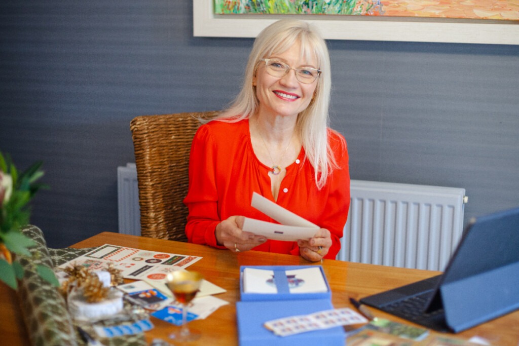 April Harris sitting at a table writing Christmas cards