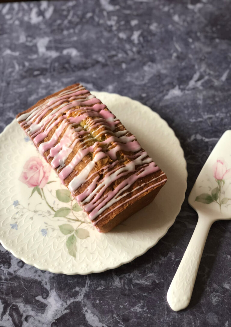 A whole Blood Orange Pound Cake sitting on an April Rose China cake plate