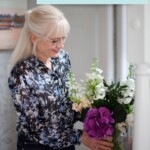 Featured photo for February 2024 Edition Hearth and Soul with April Harris arranging a vase of flowers