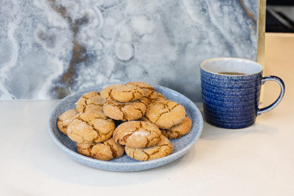 Orange Gingerbread Crinkle Cookies served on a blue plate