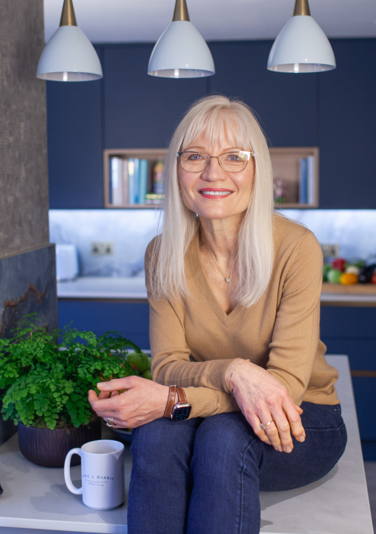 April Harris sitting on the island in her kitchen