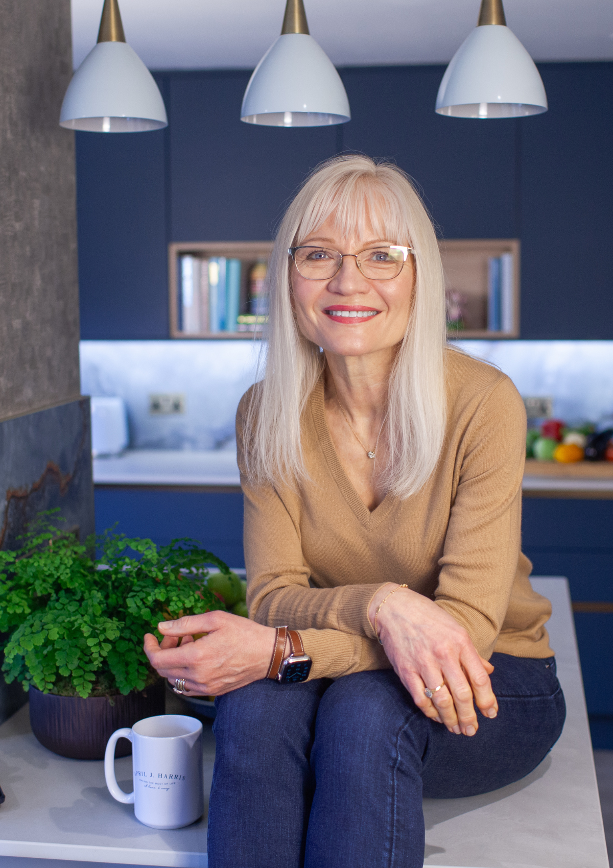 April Harris sitting on the island in her kitchen