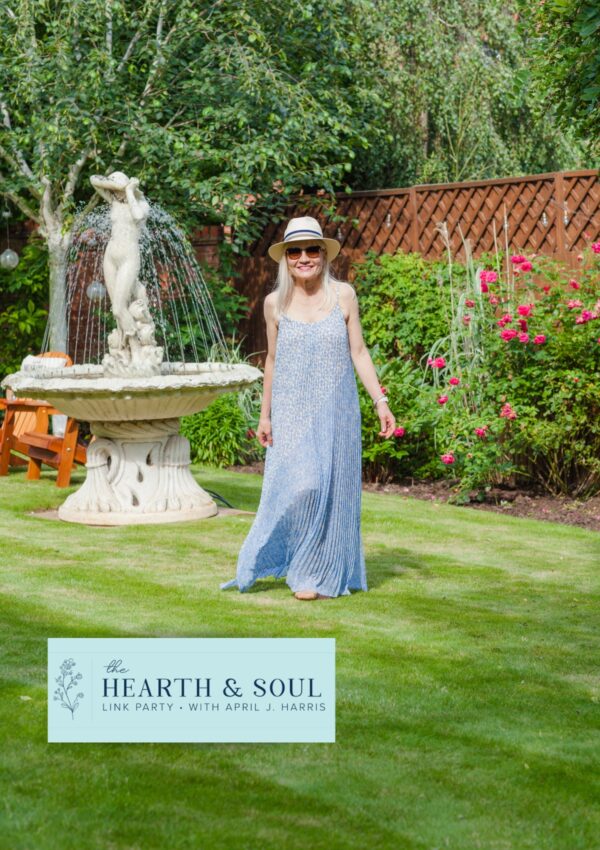 April Harris wearing a long dress by Me + Em in her garden in the header image for the Hearth and Soul Link Party July Edition