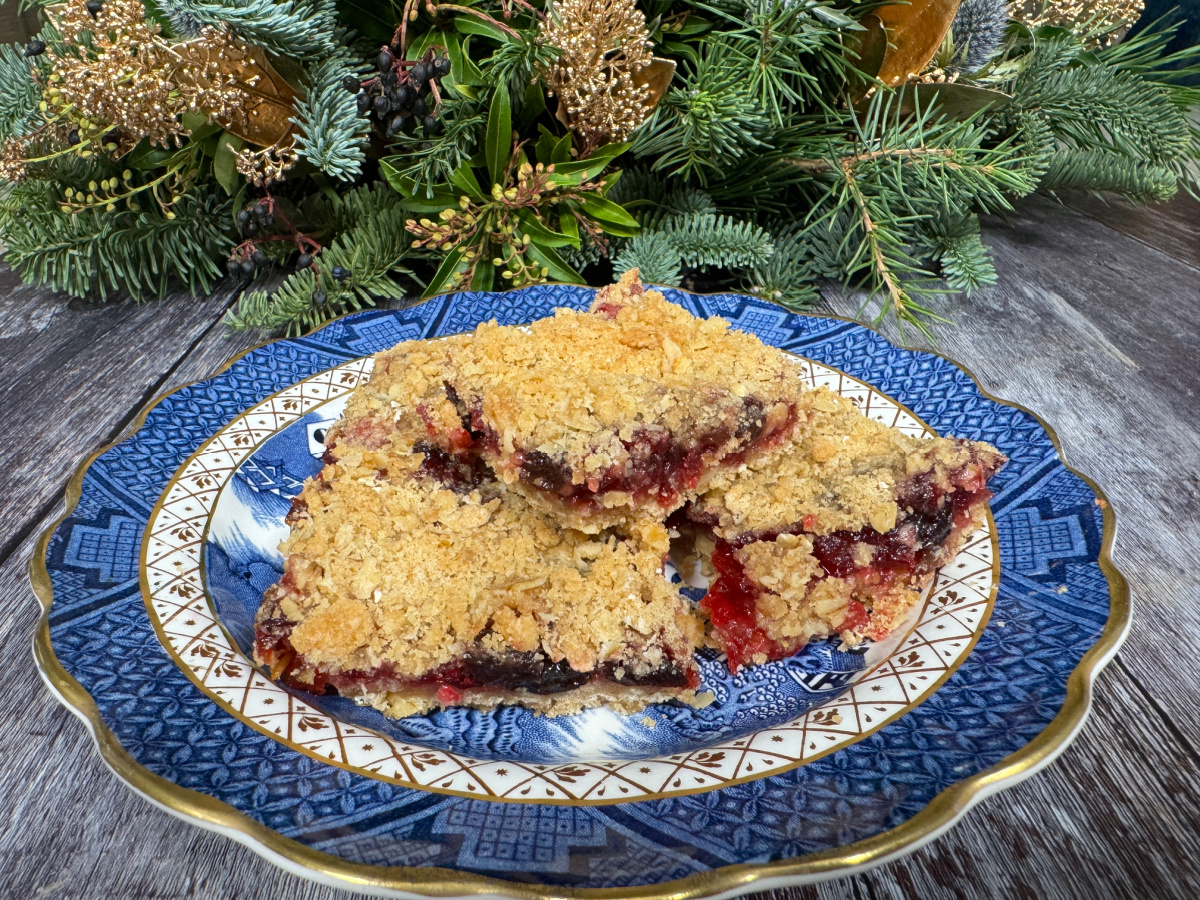 a few Cranberry Oat Crumble Bars stacked and served on a plate